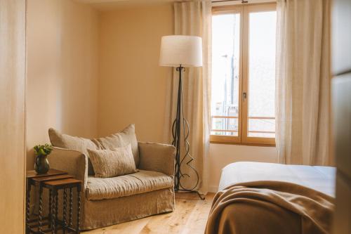 a living room with a chair and a lamp at Le Saint Hubert in Saint-Saturnin-les-Apt