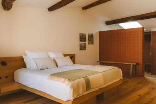 a bedroom with a large bed in a room at Le Saint Hubert in Saint-Saturnin-les-Apt