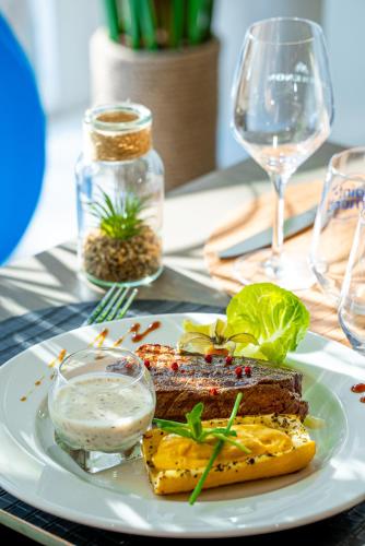 a plate of food with meat and vegetables on a table at Breeze Hotel in Calais