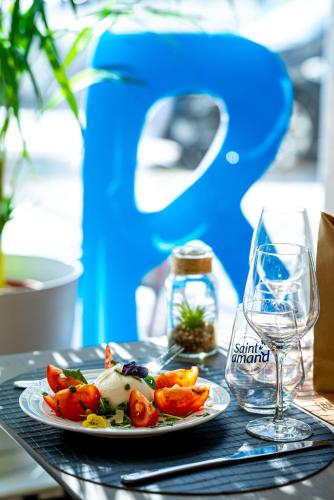 a plate of food on a table with a glass at Breeze Hotel in Calais