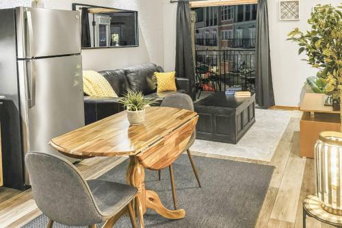a living room with a table and a refrigerator at 315A Palm Villa | European Village in Palm Coast