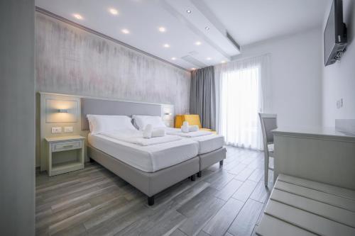 Posteľ alebo postele v izbe v ubytovaní Hotel Villa Paradiso Suite