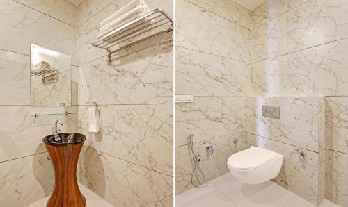 a bathroom with a toilet and a glass shower at Itsy Hotels Vedansh in Ludhiana