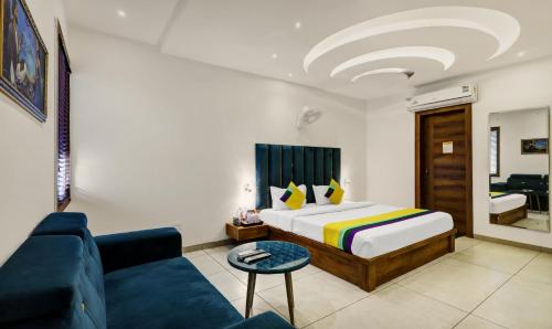 a hotel room with a bed and a couch at Itsy Hotels Vedansh in Ludhiana