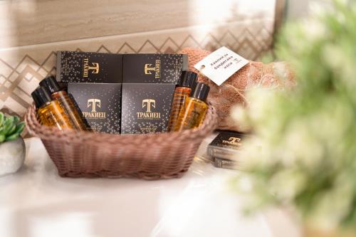 a basket of wine bottles and books on a counter at Boutique Complex Trakiets in Zhitnitsa