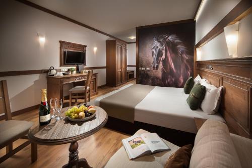 a hotel room with a horse painting on the wall at Boutique Complex Trakiets in Zhitnitsa