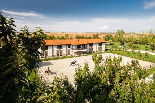 a building with two people riding horses in a courtyard at Boutique Complex Trakiets in Zhitnitsa