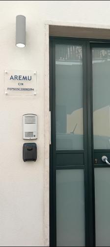 a door with a sign on the side of a building at AREMU in Lecce