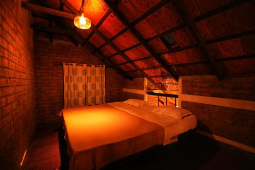 a bedroom with a bed in a brick room at Annapara Homestay in Vythiri - Wayanad in Vythiri