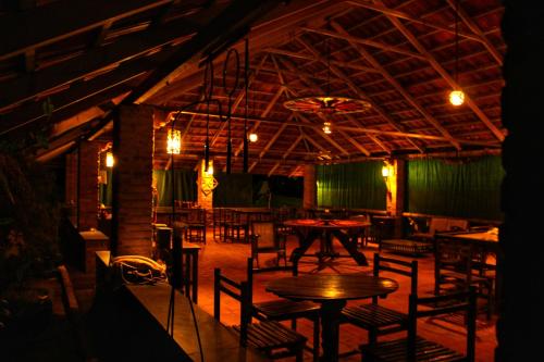 a restaurant with tables and chairs in a room at Annapara Homestay in Vythiri - Wayanad in Vythiri
