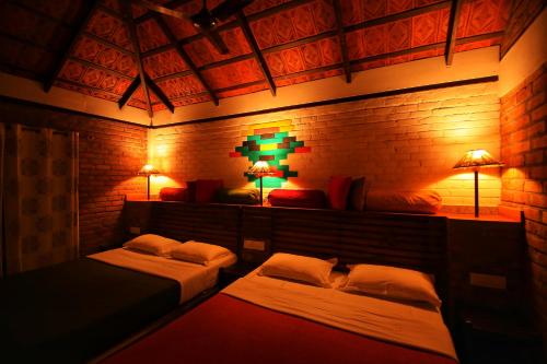 a room with two beds and two lamps in it at Annapara Homestay in Vythiri - Wayanad in Vythiri