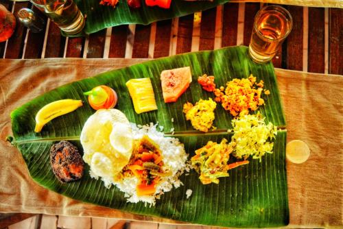 a green plate of food on a banana leaf at Annapara Homestay in Vythiri - Wayanad in Vythiri