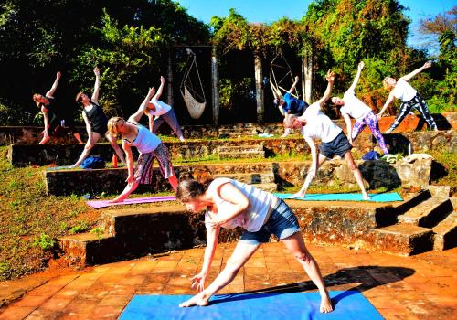 a group of people doing a yoga pose on mats at Annapara Homestay in Vythiri - Wayanad in Vythiri