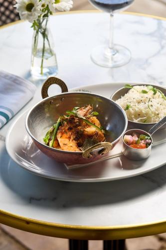 a pan of food on a plate with rice at The Stag on the River in Godalming