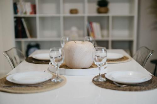 a table with plates and wine glasses on it at Loft lumineux ! wifi à 20min de Rennes in Bain-de-Bretagne