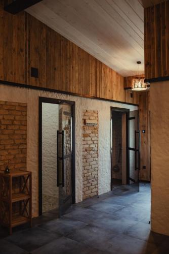 an empty room with wooden walls and wooden ceilings at Seaside Apartments Roja in Roja