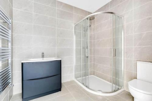 a bathroom with a shower and a sink and a toilet at BayView Luxury 3 Bedroom Apartment First Floor in Downings
