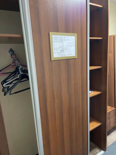 a closet with a wooden door with a picture on it at Abu Arena Hall in Baku