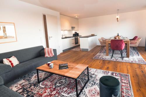 a living room with a couch and a table at HEIMATEL - Bodensee Residenz Allgäu in Scheidegg