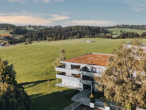 an aerial view of a building in a field at HEIMATEL - Bodensee Residenz Allgäu in Scheidegg
