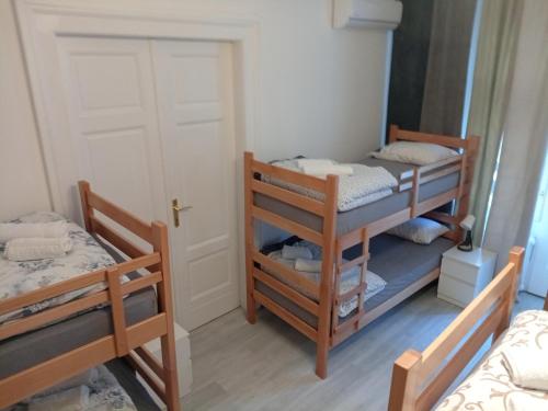 a room with two bunk beds and a door at The Horse Monument Hostel in Belgrade