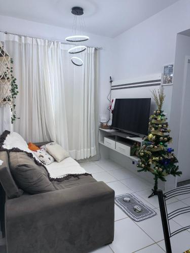 a living room with a christmas tree and a couch at Cantinho de Kelly in Santarém