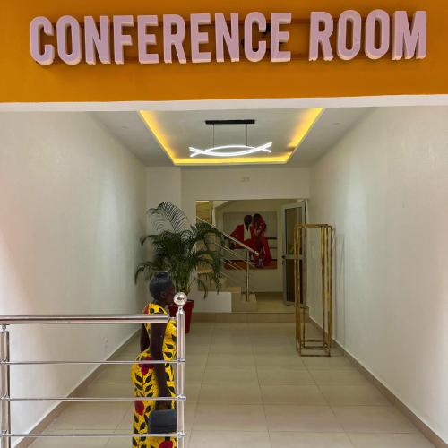 a child standing on a railing in a entrance room at Cypa Hotel in Abidjan