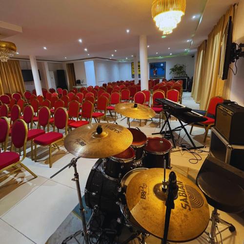 a room with a bunch of drums and chairs at Cypa Hotel in Abidjan