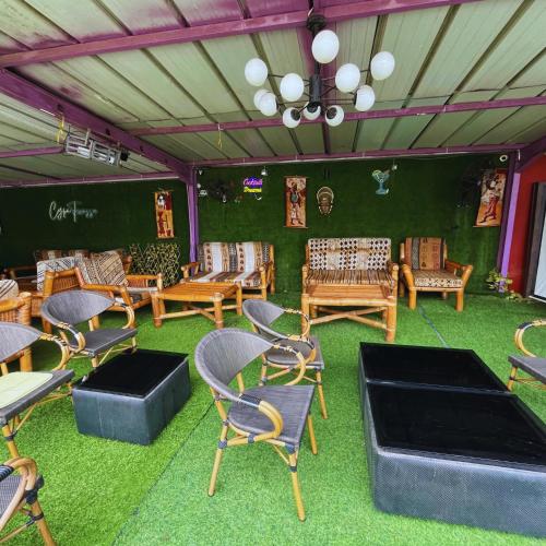 a room with chairs and tables on the grass at Cypa Hotel in Abidjan