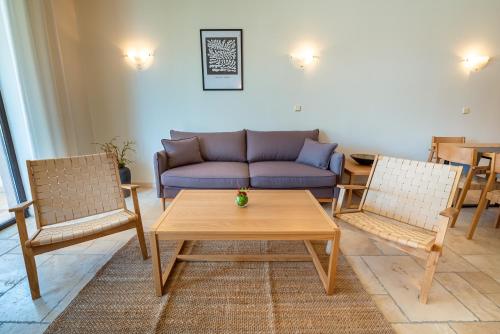 a living room with a couch and two chairs at Kaliakria Resort in Topola
