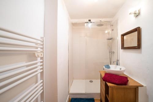 a white bathroom with a sink and a shower at Chez Draff - A 30min de Perpignan in Céret