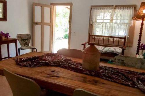 a wooden table in a room with a bed at Church Mouse House in Pilgrimʼs Rest