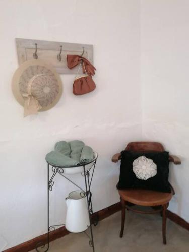 a corner of a room with a chair and a table at Church Mouse House in Pilgrimʼs Rest