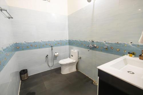 a bathroom with a toilet and a sink at Manas Jungle Retreat in Jyoti Gaon