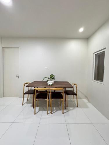 a dining room with a table and chairs at KM Suites 2BR Unit Near San Juan LU in San Fernando