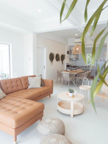 a living room with a couch and a table at Beachside Sunset Oasis at Canyon Cove in Nasugbu