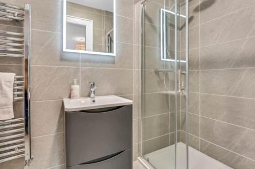 a bathroom with a shower and a sink and a shower at BayView Luxury 4 Bedroom Villa in Downings