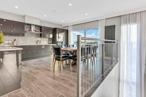 a kitchen and dining room with a table and chairs at BayView Luxury 4 Bedroom Villa in Downings