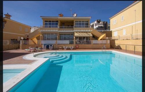 a large swimming pool in front of a building at Gran Canaria Las Palmas Apartment in Mogán
