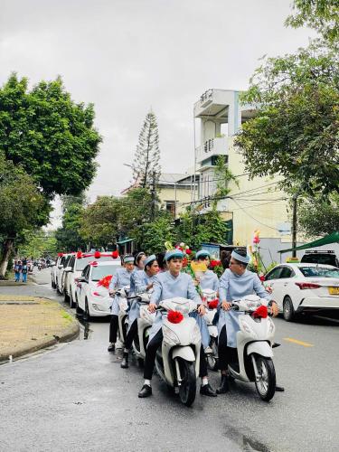 a group of people riding motorcycles down a street at KHÁCH SẠN ROMO in Quang Ngai