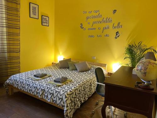 a bedroom with a bed with a table and a desk at Escuelita Viva in Ostia Antica