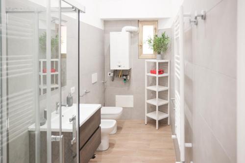 a bathroom with a toilet and a sink at Vatican Museum Apartment in Rome