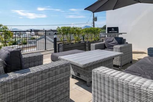 a patio with a table and chairs and an umbrella at BayView Luxury 2 Bedroom Apartment Ground Floor in Downings