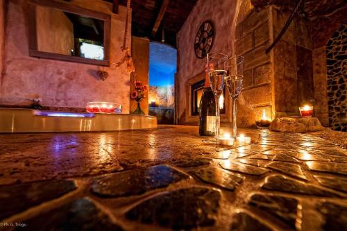 a room with a table with a bottle and candles at Il Giardino dei Flintstones B&B in Cerveteri