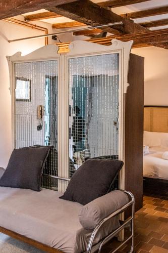 a bed in a room with a window and a bed at Mina Suites in Cervia