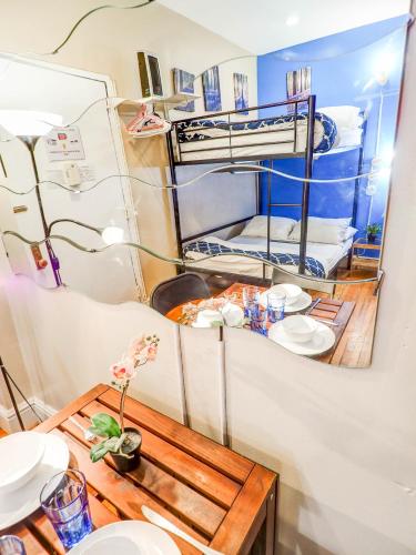 a room with a table and a bunk bed at Metropolitan Studio Apartments Manhattan in New York
