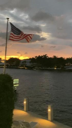 an american flag flying over a body of water at Holiday Isle Yacht Club in Fort Lauderdale
