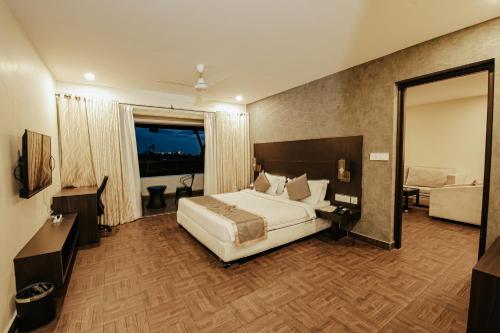 a hotel room with a bed and a couch at Avoki Resorts in Trivandrum