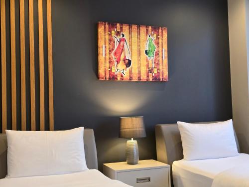 a room with two beds and a painting on the wall at Silver 39 Corner Hotel in Tbilisi City