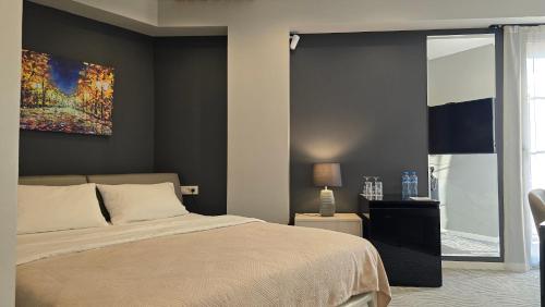 a bedroom with a bed and a painting on the wall at Silver 39 Corner Hotel in Tbilisi City